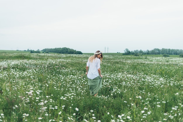 A woman in a field of chamomiles