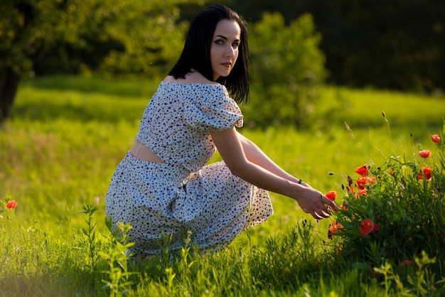 A woman in a field of red flowers