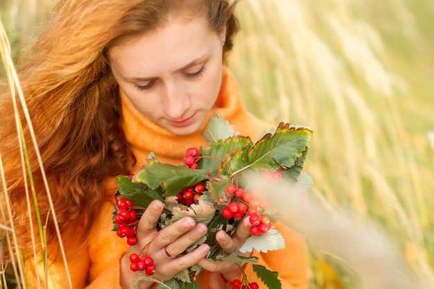 A woman in a field with berries in her hands