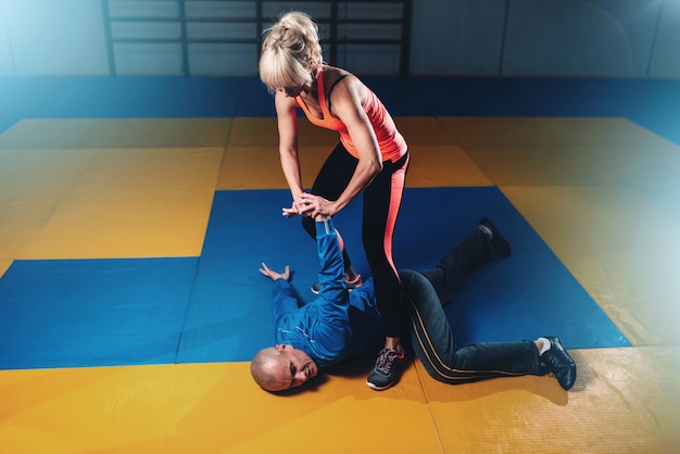 Woman fights with man, self-defense technique