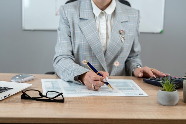 woman filling 1040 tax return form at office