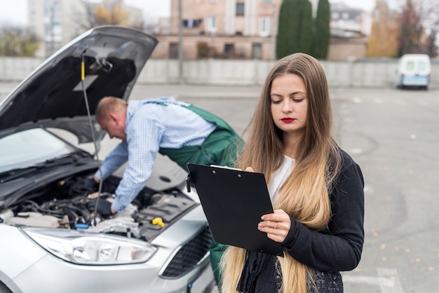 Woman filling some documents at service station