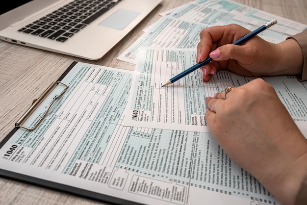 Woman fills in individual tax form 1040