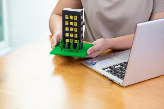 Woman fills out information on a computer to submit a condo loan for bank