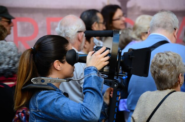 Woman filming with camera