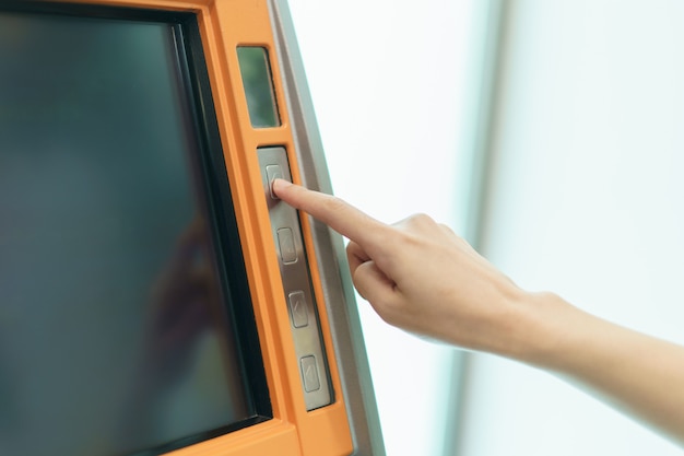 Woman finger pressing a button ATM