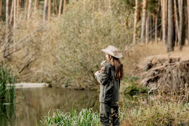 Woman fishing on the river. Fishing on a spinning rod.