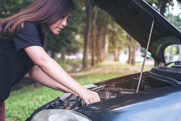 woman fixing car