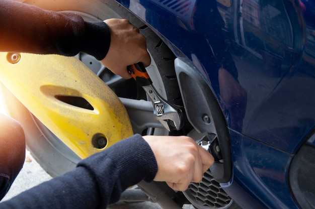 Woman fixing a motorcycle with a wrench