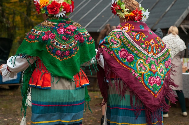 A woman in folk clothes from the back beautiful dress in the\
belarusian style traditional autumn harvest festival people and\
traditions