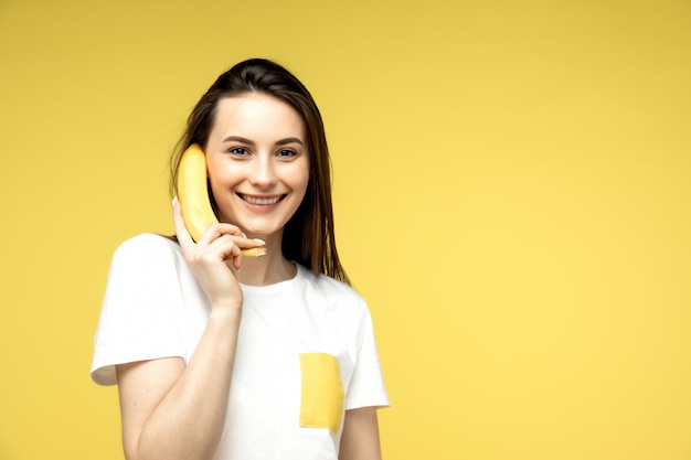 A woman fooling around with a banana