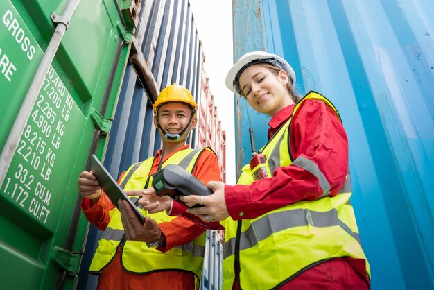 Woman foreman and operator using credit card swipe machine for\
checking code of cargo container before import exprot concept\
logistics transportation shipping lady foreman checking cargo\
warehouse