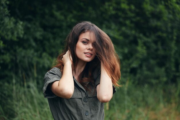 Woman in the forest Look forward smile long hair fresh air travel cropped view