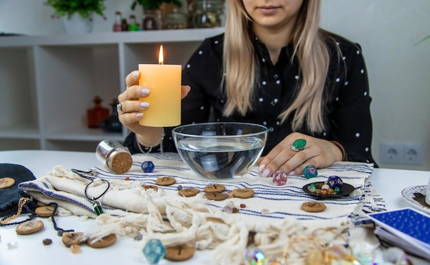 Woman fortune teller fortune telling wax candles Selective focus