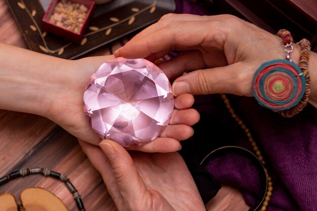 Woman fortuneteller puts a ball of fate in her hand, a magic ball of predictions. concept of predicting the future, magic, occultism.