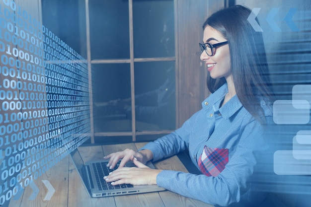 Woman freelancer is typing on laptop IT specialist and blue effects