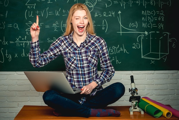 Woman freelancer with good mood using laptop computer student help homework knowledge day