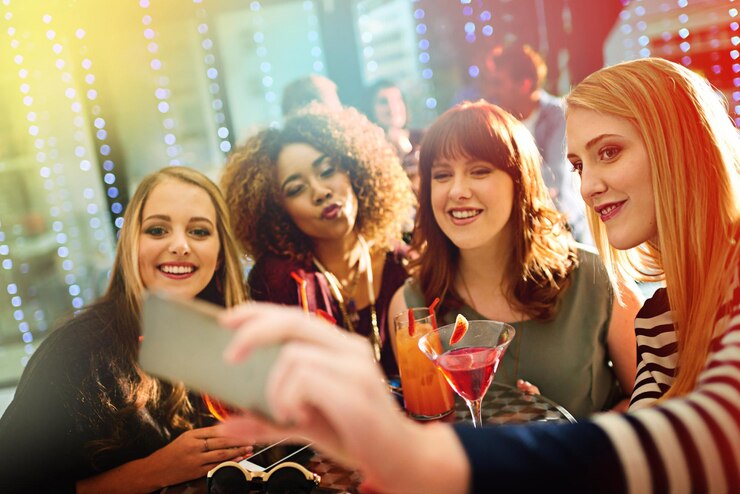 Photo woman friends and drinks or party selfie diversity and fun with alcohol or cocktails in club for entertainment smartphone happy and online for social media post technology and celebration