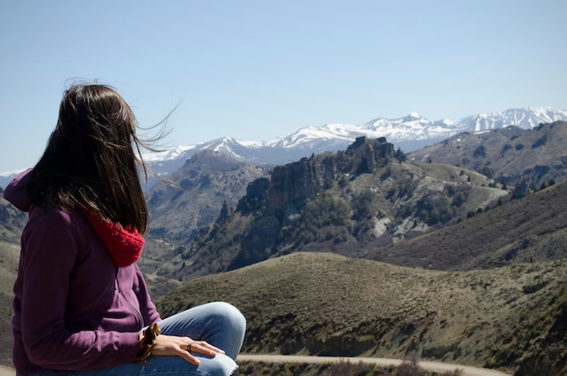 woman from behind looking at the landscape of the Andes mountain range