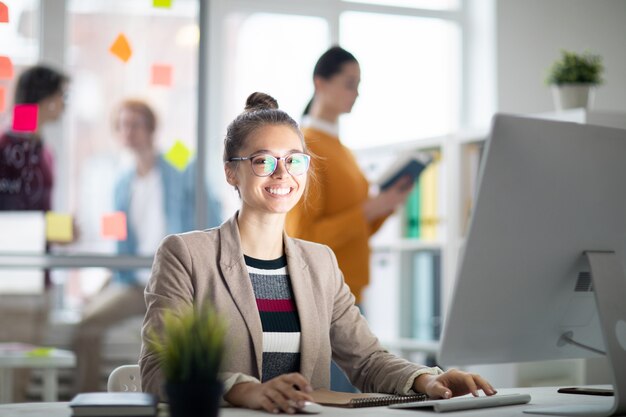 コンピューターのモニターの前の女性