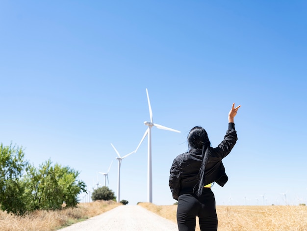 Woman in front of wind turbines ecology