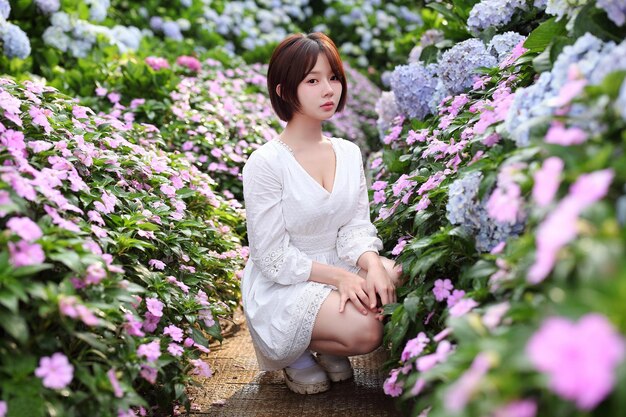 A woman in a garden of flowers