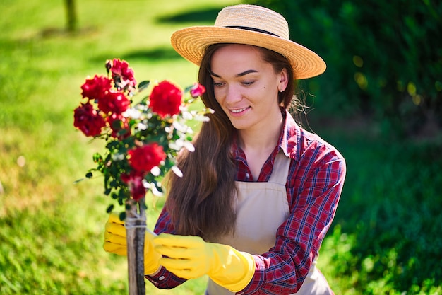 Woman gardener in flowers backyard