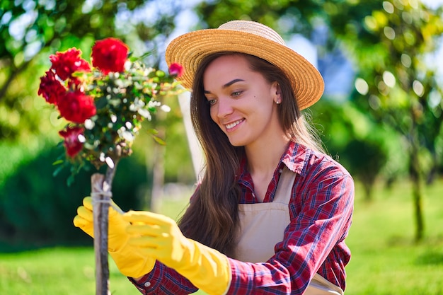 Woman gardener in flowers backyard