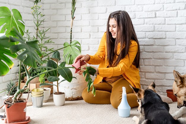 Photo woman gardener taking care of her home garden plants