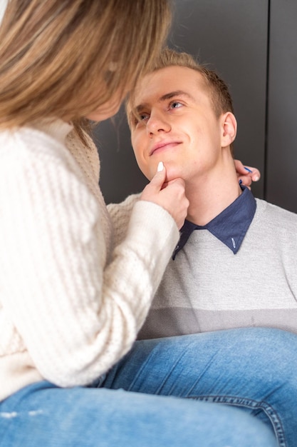 a woman gently touches a mans face their eye contact reflecting a deep and understanding connection embodying care and inclusivity