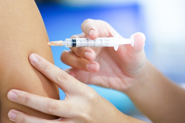 Woman get flu vaccine shot