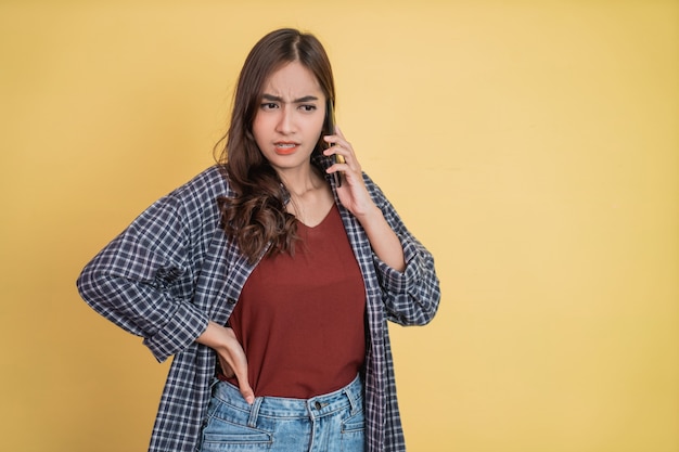 A woman gets a call from a cellphone and she is angry