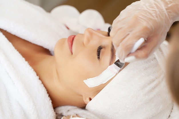 Woman gets a face mask in a beauty salon