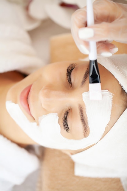 Woman gets a face mask in a beauty salon