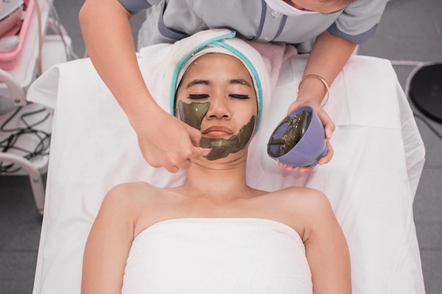 Woman getting facial nourishing mas