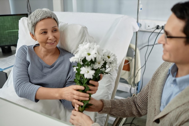 Woman getting flowers from her son