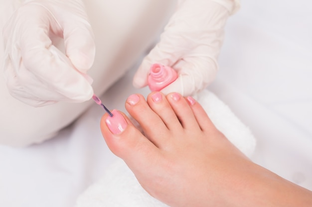 Woman getting her toenails painted