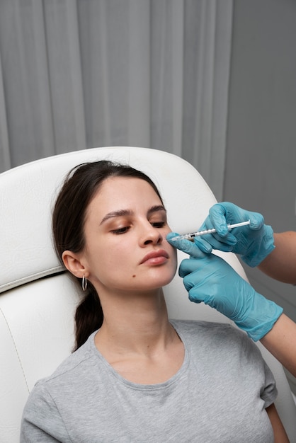 Woman getting injection at clinic high angle