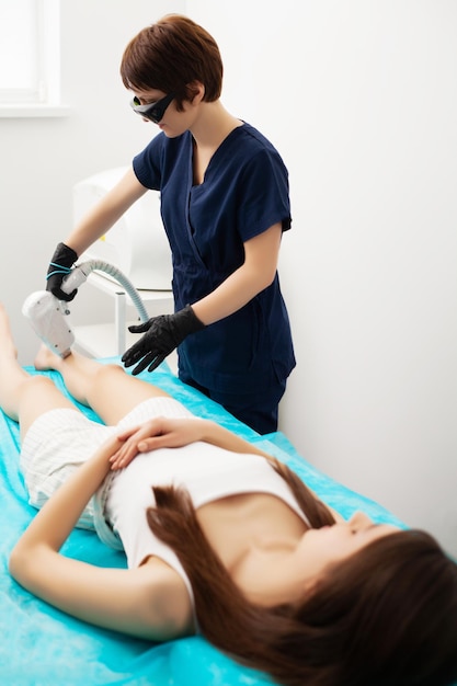 Woman getting laser treatment in a beauty salon.