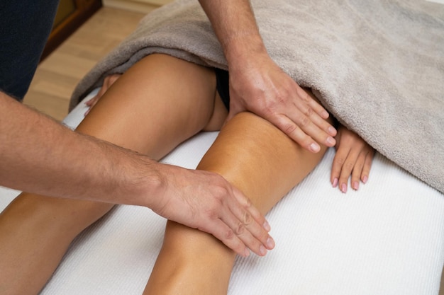 Woman getting legs massage in spa salon