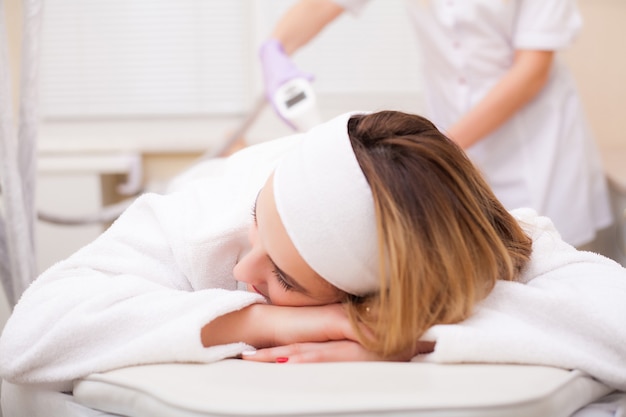 Woman getting LPG hardware massage at the beauty clinic.