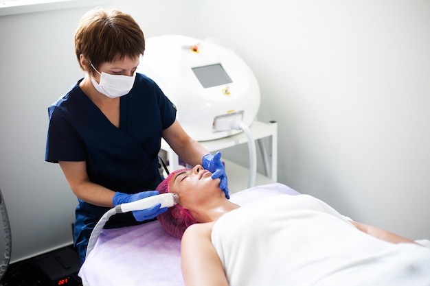 Woman getting LPG hardware massage at the beauty clinic