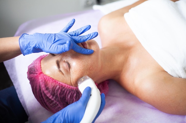 Woman getting LPG hardware massage at the beauty clinic