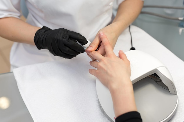 Woman getting nail manicure