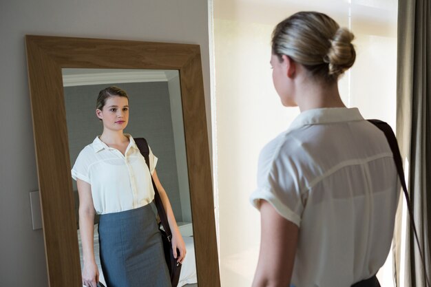 Woman getting ready for office in bedroom