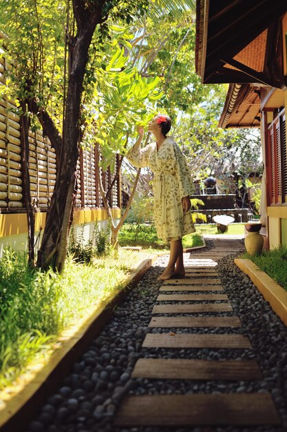 Woman getting spa treatment at tropical resort