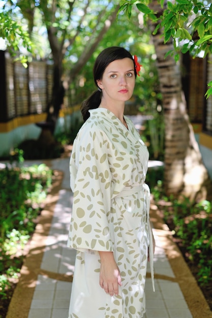 Woman getting spa treatment at tropical resort