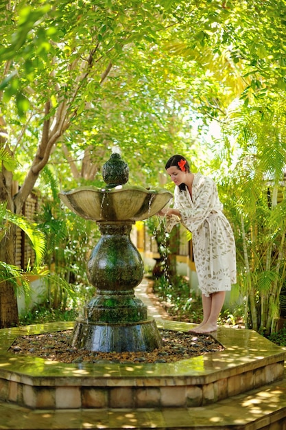 Woman getting spa treatment at tropical resort