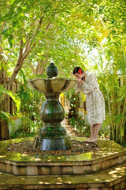 Woman getting spa treatment at tropical resort