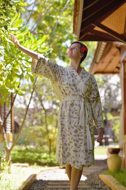 Woman getting spa treatment at tropical resort